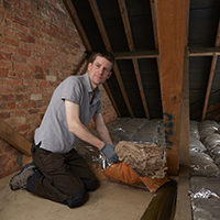 contractor installing attic insulation