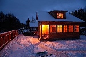 house with a snow covered roof and driveway