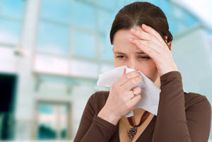 woman covering her nose with a tissue