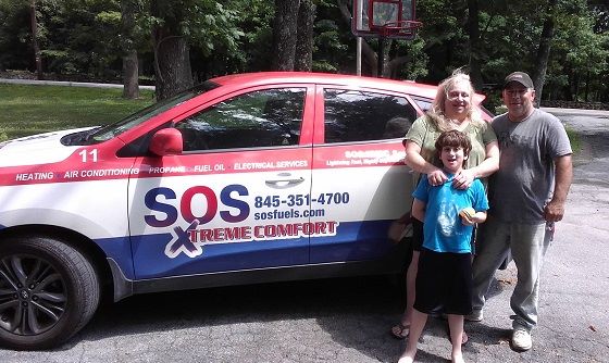 happy family standing in front of an sos xtreme comfort service care.