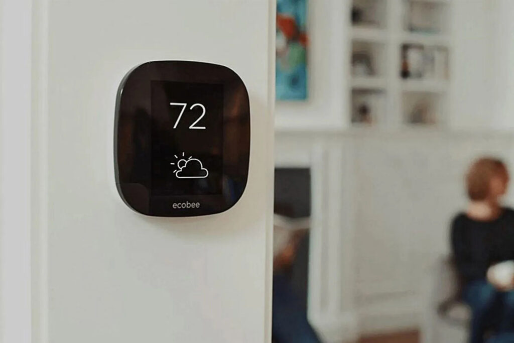 A programmable thermostat on a wall, showing 72 degrees